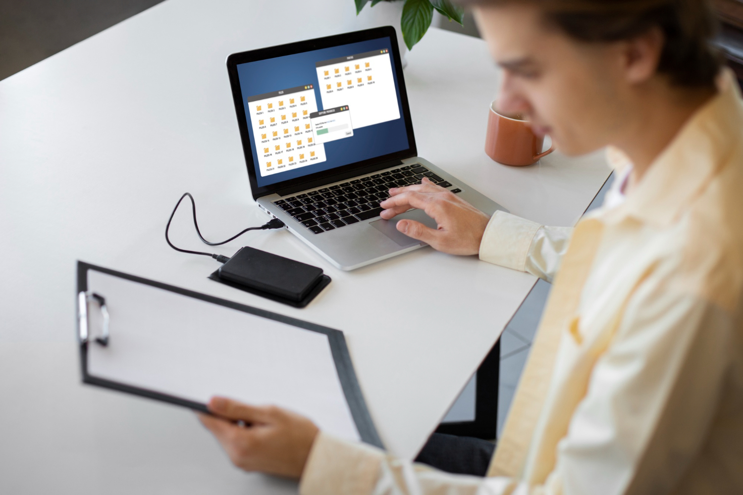 A guy downloads files from a laptop